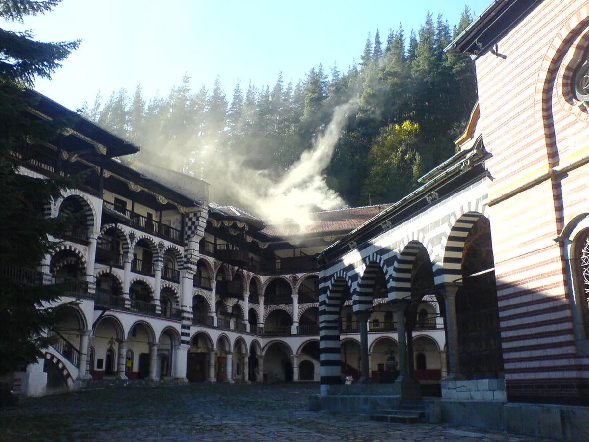 The painted arcades and mountain setting of Rila Monastery in Bulgaria
